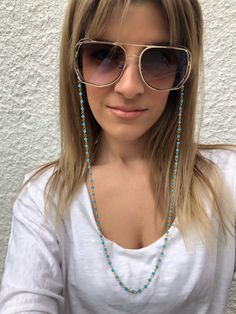 Sunglasses chain from a unique rosary with turquoise beads and gold chain. You can put it in every pair of sunglasses that you wish. In Christina Christi Jewels store you can see a lot of fashion accessories for men and women. You can have them in 2-4 Days with DHL EXPRESS SHIPPING - Rosary Chain with turquoise beads and gold chain that is made from metal. - You can choose in three different dimensions for your glasses. (70 - 80 - 90 cm) # FIND ALL MY DESIGNS IN GLASSES CHAINS HERE: https://etsy Trendy Blue Glass Necklace, Blue Glass Jewelry For Festivals, Blue Chain Jewelry For Summer, Blue Adjustable Chain Glasses Chains For Summer, Blue Adjustable Glasses Chain For Summer, Blue Beaded Glasses Chain For Beach, Summer Blue Glasses Chain With Adjustable Feature, Bohemian Blue Beaded Glasses Chains, Trendy Blue Glass Glasses Chains