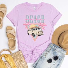 Ditch the dull and show off your wild side with our "Beach Babe Van" tee! This retro-inspired piece is just the thing to show off your cool, laid-back style with its throwback van and groovy palm tree graphics. Let's hit the beach! Size Guide: we recommend your true size for a loose fit or size down for a fitted fit. Tees are Unisex. Heather blend shirts are 52/48 Cotton/ Poly Blend and Shirts are Unisex. CREW NECK SIZING: Small - Length, 28" Width, 18" (4/6) Medium - Length, 29", Width, 20" (8/ Casual Beach T-shirt For Warm Weather, Beach Cotton T-shirt For Warm Weather, Cotton T-shirt For Beach In Warm Weather, Casual T-shirt For Beach In Warm Weather, Bohemian Short Sleeve Beach T-shirt, Bohemian Crew Neck T-shirt For Summer, Tropical Graphic Print T-shirt For Beach, Summer Cotton T-shirt For Vacation, Cotton Summer T-shirt For Vacation