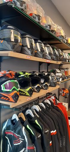 the shelves are filled with different types of helmets