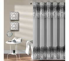 a white shower curtain with black lace on it