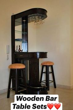 two stools sit in front of a black cabinet with a mirror on the wall