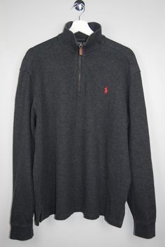 "Vintage Ralph Lauren 1/4 Zip pullover sweater in dark gray. Embroidered brand's signature polo horse in red, on the chest. - Fabric: 100% Cotton - Size tag: Please always check measurements before buying. Men's Large. - Measurements (laying flat):  Pit to Pit: 25.5\" Length: 28.5\" Pit to Cuff: 25.5\" Sleeve: 20\" Across the Shoulders: 19\" -Wear: /Please see images for details/ Very good vintage condition. -Flaws: / serious wear, tears, holes, marks or stains/ Please see images for details. None. *All of our items are preloved pieces so some signs of natural wear and age are to be expected. Please look through the photos carefully to check if the condition is to your satisfaction. *All efforts are made to show any defects however small imperfections may be missed. *We try to describe the Gray Long Sleeve Polo Sweater, Casual, Fall Cotton Crew Neck Polo Shirt, Sporty Polo Sweater With Collar For Fall, Gray Casual Polo Sweater With Ribbed Collar, Casual Gray Polo Sweater With Ribbed Collar, Casual Crew Neck Polo Shirt For Fall, Casual Winter Polo Shirt, Casual Long Sleeve Polo Shirt For Winter, Ralph Lauren Quarter Zip