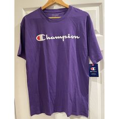 This Champion T-Shirt For Men Is A Perfect Addition To Your Athleisure Activewear Collection. The Shirt Is Made Of Cotton Fabric With A Solid Pattern, Featuring A Crew Neckline And Short Sleeves. The Purple Color And Logo Accents Give It A Colorful And Classic Look, Suitable For Outdoor Sports Activities. The Shirt Is Lightweight, Easy To Care For, And Suitable For All Seasons, Thanks To Its Moisture-Wicking And Breathable Features. With A Regular Fit And Size Type, This T-Shirt Is Perfect For M Sports T-shirt Purple With Logo Print, Purple Sports T-shirt With Logo Print, Sports Purple T-shirt With Logo Print, Purple Crew Neck T-shirt For Sports, Purple Cotton Logo Print Top, Purple Cotton Tops With Logo Print, Casual Purple T-shirt For Sports, Purple Shorts, Medium Purple