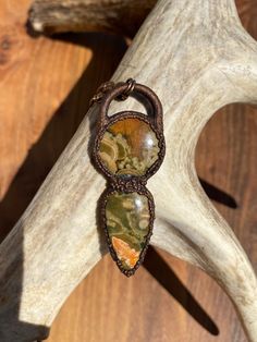 This necklace was designed with two rhyolite cabochons. A round cabochon was set above a teardrop cabochon, then they were  electroformed in copper. The formed copper was then antiqued to an aged finish to compliment the copper's texture and the beautiful rhyolite stones. Note the teardrop cabochon is a bit rough on the photo of back of the pendant. This would be a perfect gift for anyone who likes the look of organic, natural crystal jewelry! This rhyolite necklace was handmade by me in Calgary Teardrop Jasper Jewelry With Natural Stones, Artisan Jasper Teardrop Jewelry, Handmade Jasper Oval Necklaces, Handmade Jasper Round Necklaces, Handmade Jasper Oval Necklace, Handmade Oval Jasper Necklaces, Handmade Round Jasper Necklaces, Handmade Oval Jasper Necklace, Handmade Oval Moss Agate Necklace