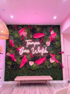 there is a pink and green wall in the room with flowers on it that says tampa bay beach