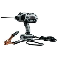 a corded drill is plugged in to a charger on a white background