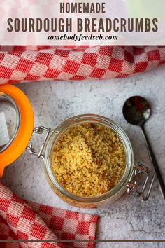 homemade sourdough breadcrumbs in a glass jar on a red and white checkered cloth