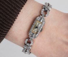 "Waltham 1920s Watch This antique Waltham watch is platinum and covered in 2 carats of diamonds! Quite the elegant timepiece! There is a beautiful mixture of single cut and baguette diamonds. The clasp is a two part latch for extra safety! This piece has been evaluated by an expert, and it works wonderfully. Antique Watch - Antique Ladies Waltham 1920's Platinum Diamond Wrist Watch Waltham 1920's Platinum Total Diamond Weight is 2cts Watch length measures approximately 7\" long. Please read thro Vintage Watches Antique, Antique Wedding Bands, Antique Watch, Watch Jewelry, Used Watches, Old Watches, Gold Diamond Wedding Band, Vintage Wedding Band, Antique Wedding