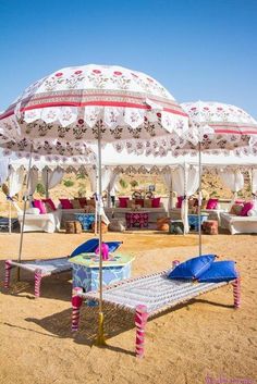 an umbrella and chaise lounge set up on the beach