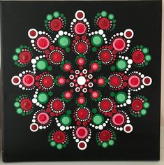 a painting with red, green and white circles in the center on a black background