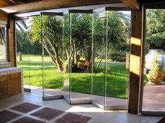 an outdoor kitchen with sliding glass doors to the outside