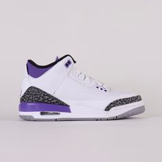 a white and purple sneaker with leopard print on the upper part of the shoe