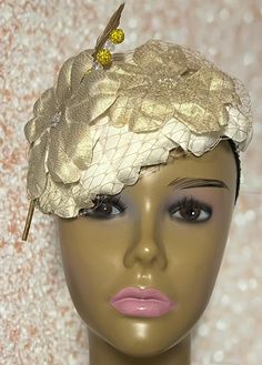 Gold and Cream Flower Fascinator Half Hat, Weddings, Church, Tea Parties, and Other Special Occasions  Accented with veil netting, feather, hat pin, and iridescent flower. The hat pin may vary and is for decorative purposes only. The hat is affixed to the head via a hatstring. Available in 2 sizes: 8 X 5.5 inches  10 X 7 inches The mannequin is wearing the 8 by 5.5 inches. Handmade Gifts for mom, sister, wife, or yourself. SHIPPING  All items for free shipping will be shipped via USPS FIRST CLAS Luxury Cream Hat Headpiece, Elegant Hair Accessories For Spring Ceremonies, Elegant Wedding Headpiece With Flower Decoration, Elegant Spring Ceremony Hair Accessories, Elegant Floral Wedding Headpieces, Adjustable Fascinator For Wedding, Elegant Costume Hat With Handmade Flowers, Elegant Handmade Flowers Costume Hat, Spring Wedding Hat-style Headband