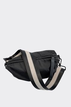 Nylon material with an adjustable web and leather strap to allow you to wear this 3 ways-around your waist, shoulder or as a crossbody. Fun voluminous shape makes this bag unique and sporty too! Go hands free for your life on the go. Available in 6 colors: Black/Cream (as shown), Black/Matte Black, Black/Shiny Black, Navy, Olive and SandInside slip pocketStrap fits most waists Content:- Nylon - Leather - Imported Size:- Width: 9"- Height: 6"- Depth: 4" Bags 2022, Black Matte, Black Cream, Hands Free, Orlando, Crossbody Bags, Gym Bag, The Go, Matte Black