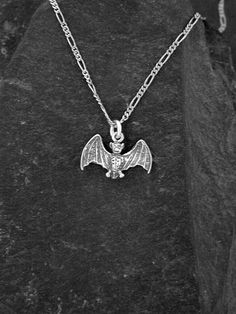 "This solid 3 Dimensional Bat pendant is Sterling Silver. The included chain is a Sterling Silver 18\"Figaro 50 chain. You may chose 16\", or 20\" chain instead at no extra charge. I hand cast all my pieces using the lost wax casting method. The Bat pendant measures 9/16\" tall by 7/8\" across. Please ask your needs. You may call me with questions, often I am out so please use my machine. Call Pete Conder 831-476-3176. Satisfaction Guaranteed! I send items USPS First Class unless otherwise direc Symbolic Sterling Silver Chain Jewelry, Halloween Engraved Metal Necklace, Gothic Sterling Silver Chain Necklace, Silver Gothic Box Chain Jewelry, Handmade Gothic Chain Necklace Gift, Gothic Silver Box Chain Necklace, Engraved Necklaces For Halloween Gifts, Engraved Halloween Pendant Jewelry, Halloween Engraved Necklace Gift