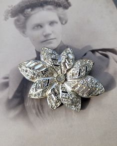 Lovely WW2-era glittering rhinestone brooch! It has a bit of yellowing on a few stones but is in good condition, particularly for its age. Please see pictures for details and measurements. Thanks for looking! Vintage Rhinestone Brooches For Vintage Events, Vintage Rhinestone Brooches For Anniversary, Vintage Sparkling Brooches For Formal Wear, Vintage Sparkling Brooches For Formal Occasions, Vintage Sparkling Brooch For Formal Occasions, Vintage Bling Brooches For Anniversary, Vintage Sparkling Wedding Brooches, Rhinestone Brooches, Floral Vintage