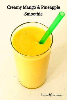 an orange smoothie in a glass with a green straw and the words creamy mango & pineapple smoothie