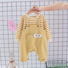 2-piece Striped Sweatshirt & Bib Pants for Toddler Boy Wholesale Children's Clothing - PrettyKid Yellow Cotton Long Sleeve Sets, Casual Yellow Sets With Long Sleeves, Casual Yellow Long Sleeve Sets, Yellow Long Sleeve Sets For Spring, Spring Yellow Long Sleeve Sets, Cute Long Sleeve Sets With Pockets, Yellow Cotton Fall Set, Cute Cotton Sets With Pockets, Playful Yellow Long Sleeve Sets