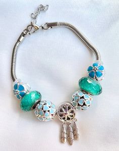 a bracelet with beads and charms on it