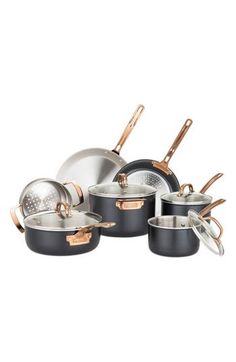 an assortment of pots and pans with copper handles