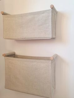 two linen storage bins hanging on the wall