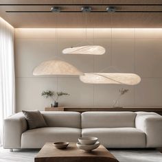 a living room filled with furniture next to a wall mounted light above a coffee table