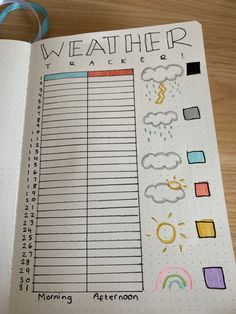 an open planner with weather and rainbows on the pages, next to a blue ribbon