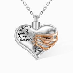 a heart shaped necklace with words on it and two tone gold accents in the center