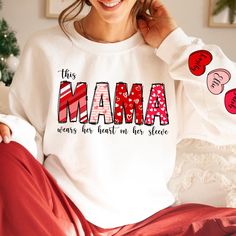 Custom Valentine Mama Sweatshirt with Kids Name on Sleeve, I Wear My Heart On My Sleeve Sweatshirt, Mothers Day Gift For Mom, Valentine Gift A T-shirt is a daily must-have item you should have in your wardrobe. Our designed T-shirts are quite easy for you to wear or mix with other items. Above all, it's extremely convenient and suitable for any gender. You can wear our designs anywhere you want: at home, at a gym, or hang out with friends. Our shop wants to bring you trendy, quality and cost-effective shirts. PRODUCT DETAILS: * This unisex fit t-shirt is intended to be loose/oversized for women to give a chic and laid back vibe. If you want the tee to be more fitted, we would recommend sizing down. * Detailed sizing information can be found in the size chart in the photos. * Printed in the Valentine's Day Long Sleeve Cotton Tops, Long Sleeve Letter Print T-shirt For Valentine's Day, Long Sleeve T-shirt With Letter Print For Valentine's Day, Valentine's Day Long Sleeve T-shirt With Letter Print, Long Sleeve Slogan Top For Mother's Day, Mother's Day Slogan Sweatshirt With Long Sleeves, Cute Long Sleeve Mother's Day T-shirt, Cute Long Sleeve T-shirt For Mother's Day, Long Sleeve T-shirt With Heart Graphic For Gift