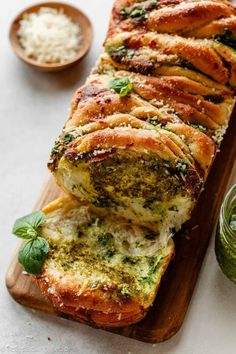 a loaf of bread with pesto and cheese