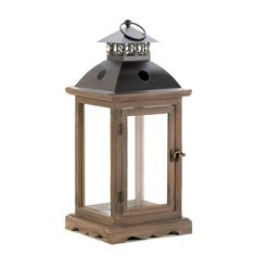 an old fashioned wooden lantern with a metal top and candle holder on the front side