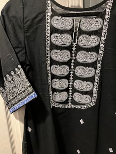 Beautiful Pakistani/Indian kurti by khaadi in black with white embroidery and prints. Festival Salwar Kameez With Printed Motifs In Black, Black Long Sleeve Salwar Kameez With Printed Motifs, Festival Salwar Kameez In Black With Printed Motifs, Black Salwar Kameez With Printed Motifs For Festivals, Black Traditional Wear With Printed Motifs For Transitional Season, Black Kurta With Printed Motifs For Transitional Season, Black Bollywood Traditional Wear With Printed Motifs, Black Dupatta With Printed Motifs For Diwali, Traditional Printed Motifs Kaftan Tunic