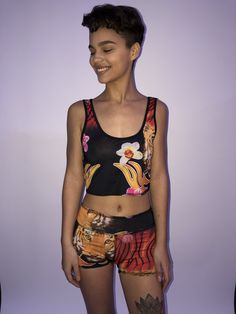 These comfortable and cute cropped bralets can be worn with the matching sports bra for added support. Paired with one of the many matching shorts, this top can be worn in the studio, as a bathing suit or out on the street. double sided with 2 different yet complimenting prints, made from recycled water bottles and spandex UV protection Casual Sports Crop Top With Built-in Bra, Summer Sports Tank Top With Built-in Shorts, Moisture-wicking Short Summer Tops, Summer Gym Tops Short Length, Casual Training Crop Top With Built-in Bra, Summer Gym Tops Short, Summer Gym Tops Short Style, Trendy Cropped Sports Bra For Loungewear, Athleisure Crop Top With Built-in Bra For Beach