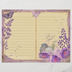 an open notebook with purple flowers and birds on the pages, lined in yellow paper