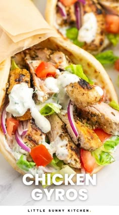 chicken falafel wrap with lettuce, tomatoes and onions on it