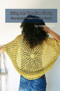 a woman with her back to the camera wearing a yellow crochet shawl