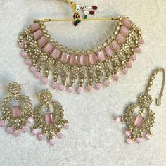 Stylish antique gold choker set with matching earrings and tikka. A light weight antique gold choker adorned with champagne zircon crystal and pink beadwork. Measurements (Approxiamtely) Choker 2.75 (Adjustable with string  Tikka  2.5 inch pendant x 1 inch x 2 inch pearl chain Earrings 2.5 inch x 1 inch  Ready to ship! Antique Gold Choker Set, Gold Choker Set, Pink Choker, Choker Set, Gold Choker, Jewellery Gift, Choker Necklaces, Pearl Chain, Chain Earrings