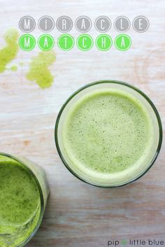 two glasses filled with green smoothie next to each other on top of a wooden table