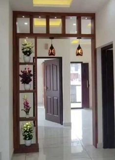 an entry way with flowers and lights on the ceiling