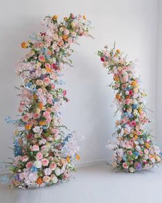 two archways made out of flowers are shown