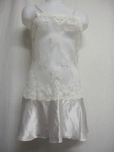 "Short White Lace and Satin Nightgown Unbelievably adorable! Sheer Baby doll /white nightie! Tons of lace with a satin flouncy skirt This is sassy! (Like You!) Small 36\" bodice 40\" Hip 32\" length Easy care poly GREAT for brides! https://www.etsy.com/shop/BelindasStyleShop" White Lace Nightgown For Wedding Night, Elegant White Lace Nightgown, Sleeveless Lace Bodice Sleepwear For Wedding, White Sheer Bedtime Dresses, Lace Coquette Camisole Nightgown, Sleeveless Lace Bodice Wedding Sleepwear, White Coquette Dress For Night, White Coquette Sleep Dress, White Coquette Night Dresses