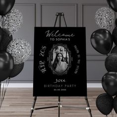 a black and white photo with balloons in the background for a 50th birthday party sign