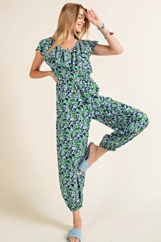 A comfortable jumpsuit with a pop of red and sprinkle of flowers. This jogger style jumpsuit has an elastic waistline, shaping the loose, lightweight fabric. There is a ruffled fabric detail along the neckline and sleeves, and side pockets. Style with sandals for a picnic in the park. Model is 5'10" and wearing her true size Small. Small: Bust 18", Length 54.5" 100% Rayon Ruffled Fabric, Jumpsuit With Pockets, Style Jumpsuit, Pop Of Red, Picnic In The Park, A Picnic, Floral Jumpsuit, Fashion Joggers, Denim Jumpsuit