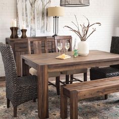 a dining room table with two chairs and a bench