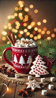 hot chocolate with marshmallows and cinnamon in a red mug surrounded by christmas decorations