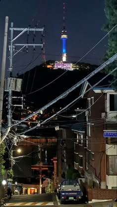 a city street at night with power lines and telephone poles