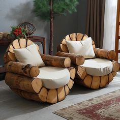 two chairs made out of logs sitting in a living room next to a christmas tree