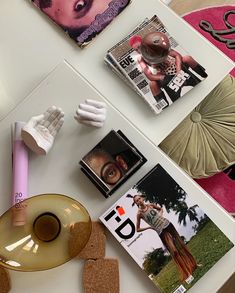 the table is covered with magazines and other items