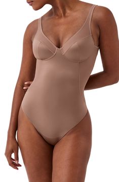 Smooth your silhouette with a shaping bodysuit that eliminates visible panty lines. Unlined cups provide light support to complete the foundational look. Medium compression Cotton-lined gusset 72% nylon, 28% elastane with 65% nylon, 35% Lycra® Xtra Life™ elastane contrast Machine wash, dry flat Imported Solid Contoured Full Coverage Bodysuit, Fitted Shapewear With Built-in Cups, Beige Full Coverage Bodysuit With Built-in Bra, Contoured Full Coverage Bodysuit With Lined Body, Elegant Second-skin Nylon Shapewear, Elegant Seamless Beige Bodysuit, Elegant Beige Seamless Bodysuit, Sculpting Beige Shapewear, Fitted Beige Underwire Shapewear