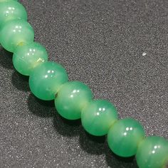 *Description: This necklace is made from faux jade green glass beads that have small air bubbles in them from the 1930s or before. They would be perfect to restring as they are most likely antique beads and the metal plated findings did not hold up as well as the glass beads. Unchecked from a gem tester, you would believe these to be jade but they are indeed glass. Looking closely with a loop, you can see the air bubbles within many of the glass beads. The necklace is 15 inches in length. This w Green Rondelle Beads Jewelry 8mm, Green Aventurine Beaded Hand-strung Necklace, Green Aventurine Beaded Necklace With Polished Beads, Green Aventurine Beaded Necklaces, Green Aventurine Round Beaded Necklaces, Green Oval Jade Beads Jewelry, Green Aventurine Round Beaded Necklace, Green Aventurine Bead Necklace, Green Oval Beaded Jewelry 8mm